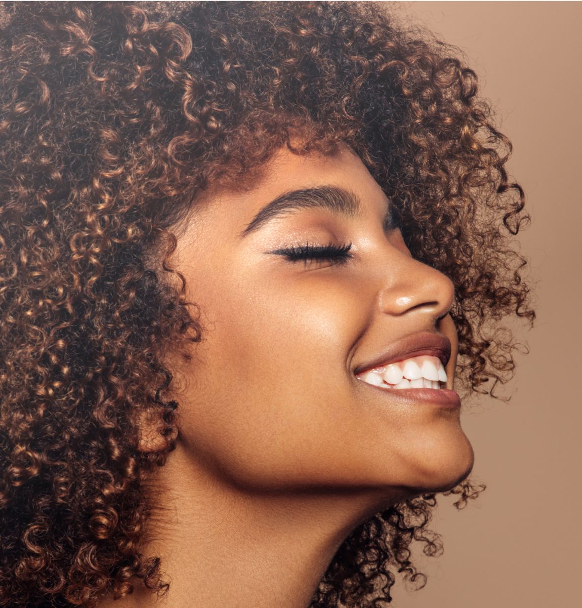 Model with long hair and striking blue eyes.