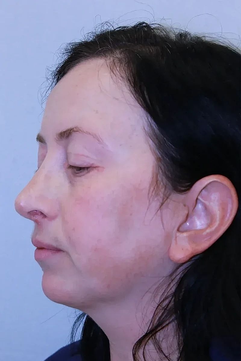 Profile view of a woman with dark hair.