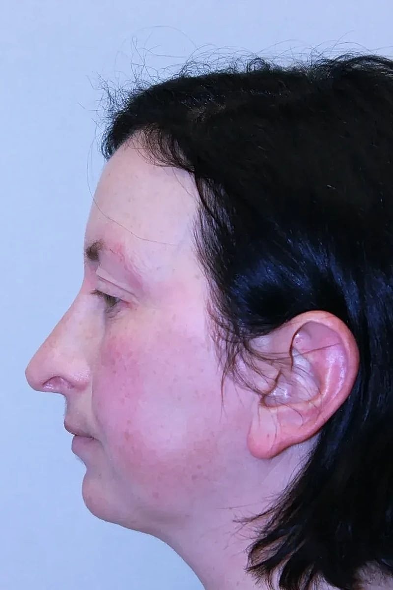 Profile view of a woman with dark hair.