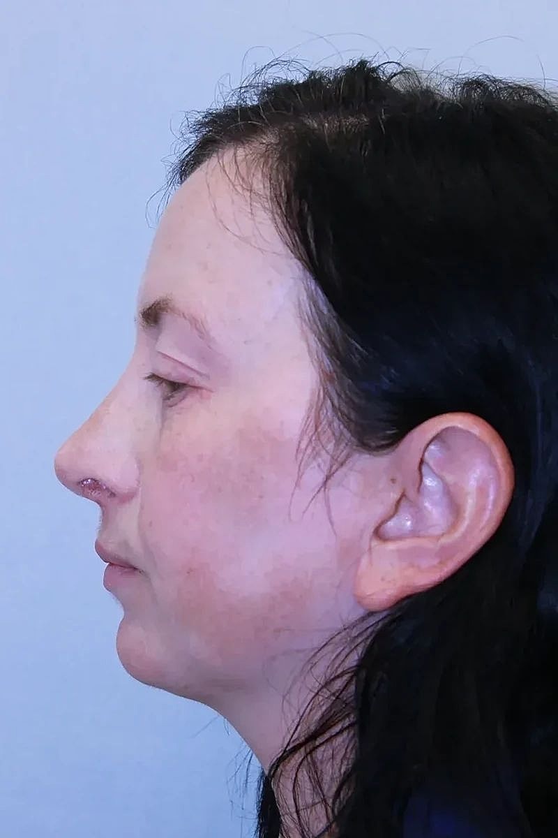 Profile view of a woman with dark hair.