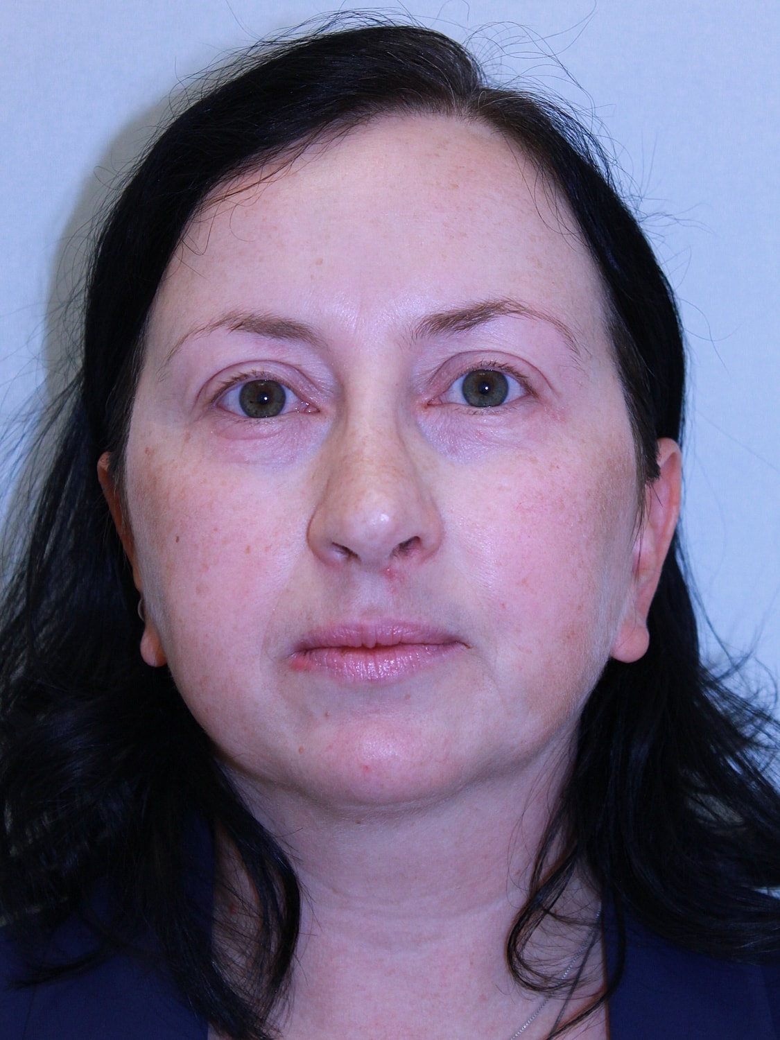 Portrait of a woman with dark hair.