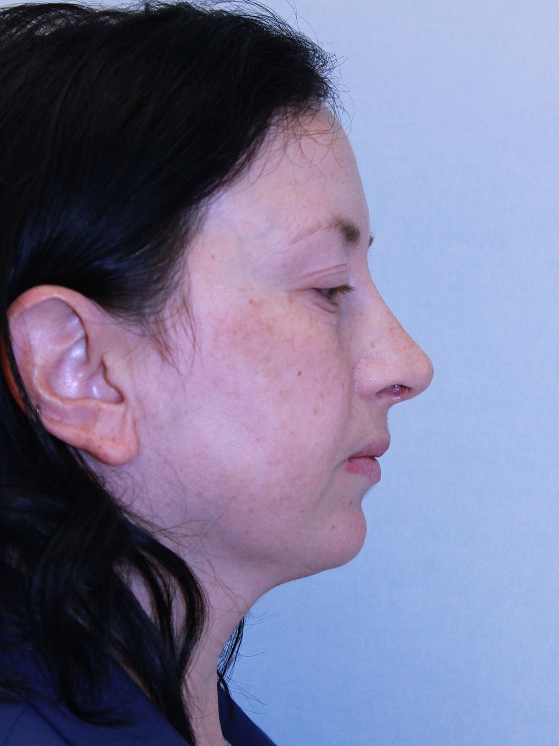 Profile view of a woman with dark hair.