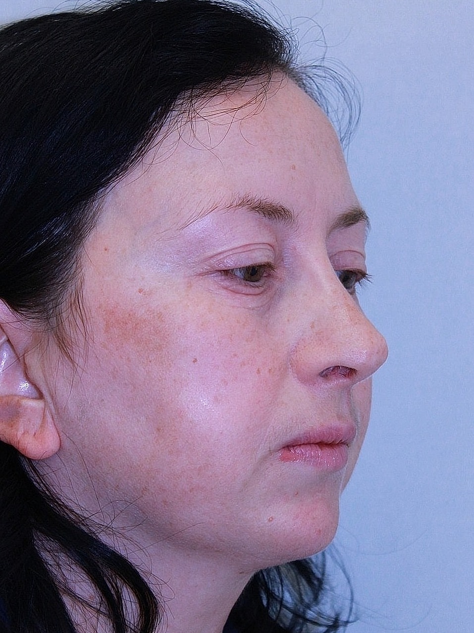 Profile view of woman with dark hair.