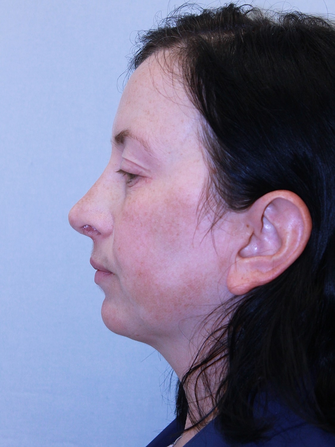 Side profile of a woman with dark hair.