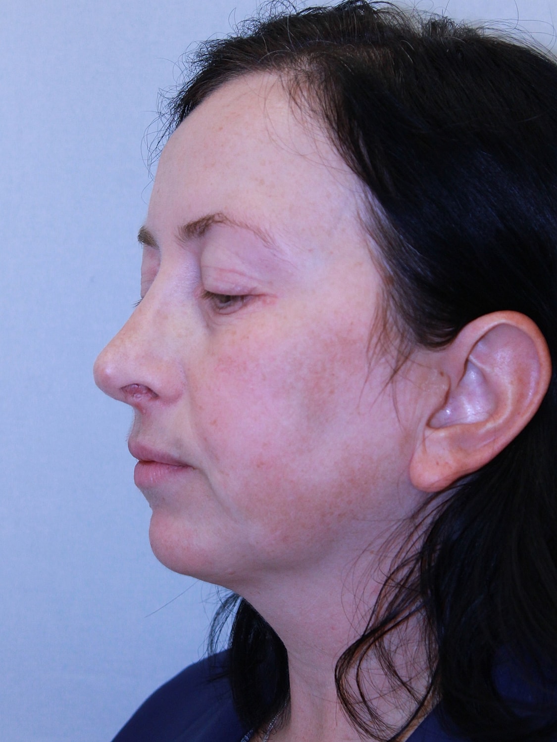 Profile view of a woman with dark hair.