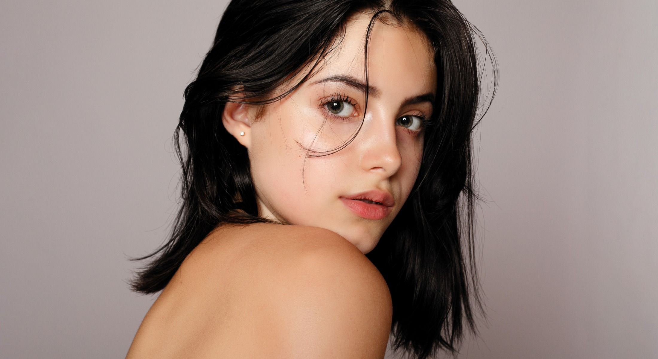 Portrait of a young woman with dark hair.