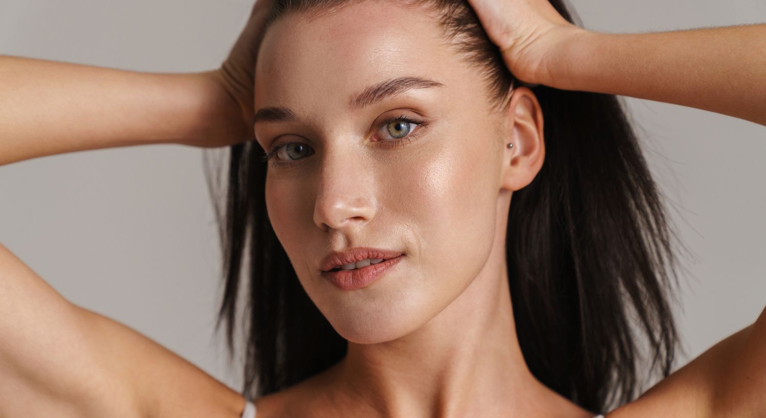 Woman touching her hair, natural beauty portrait.