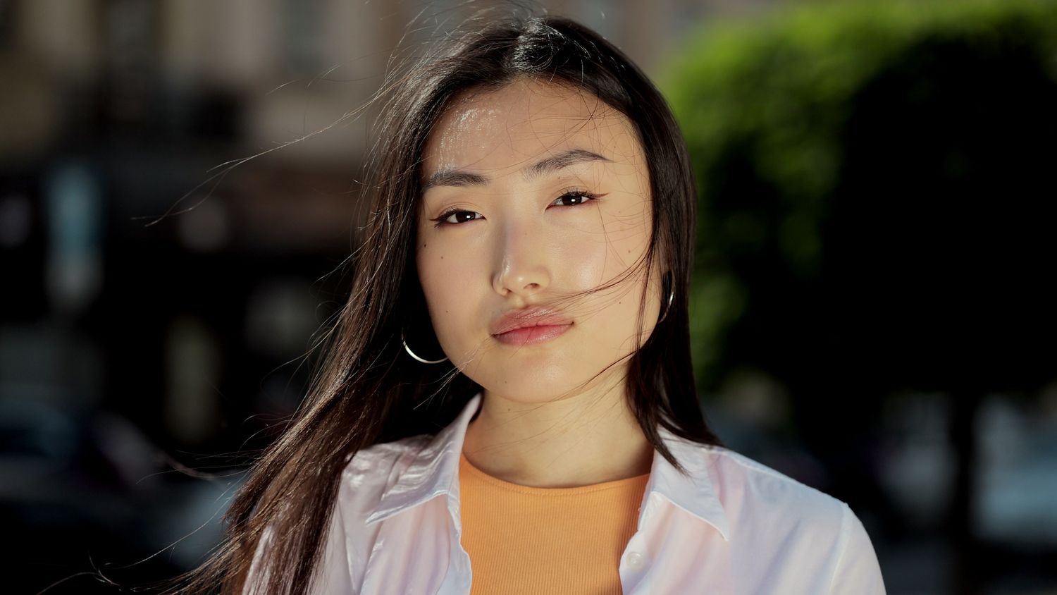 Woman with long hair and natural makeup.