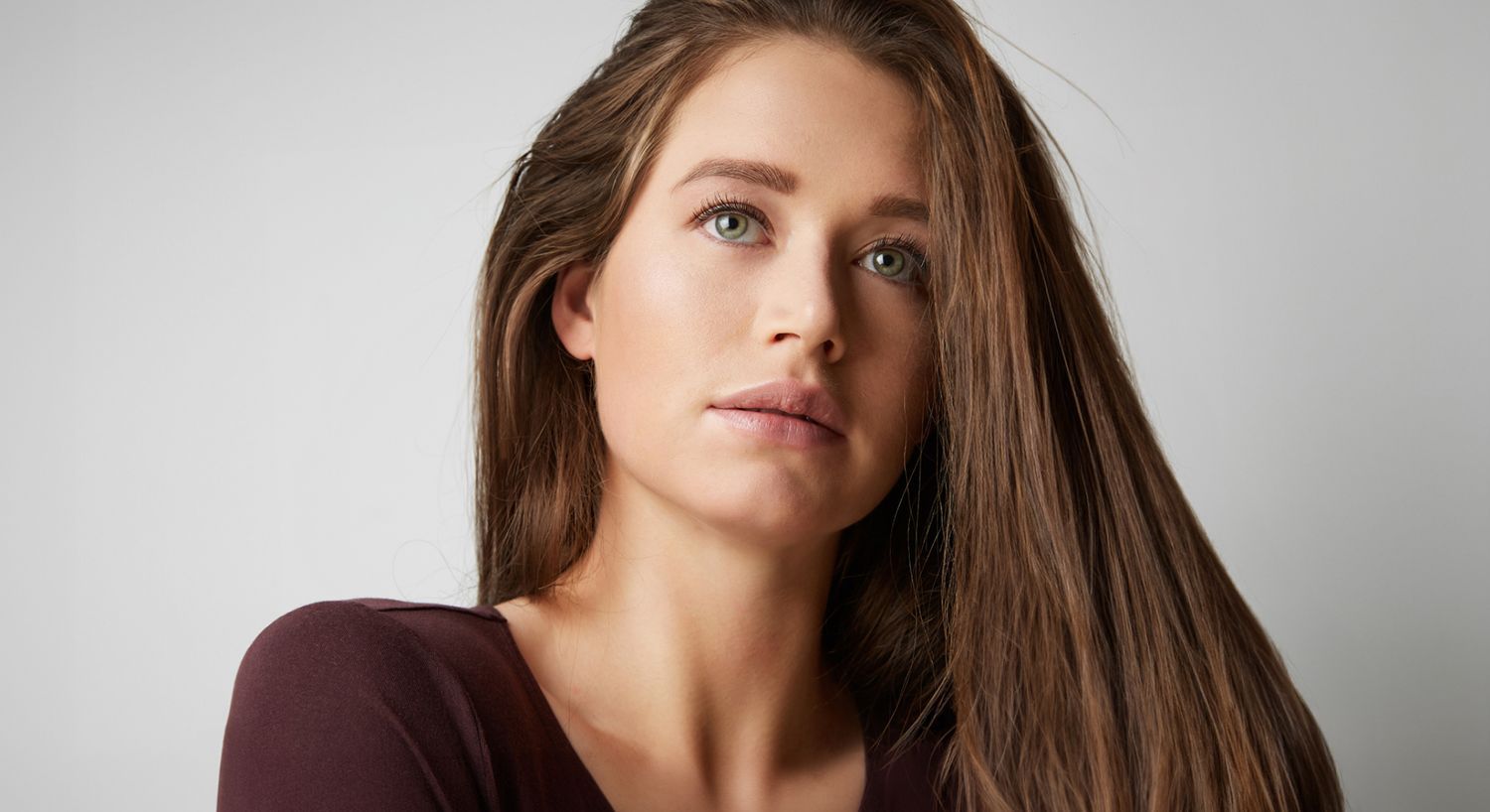 Woman with long hair and natural makeup.