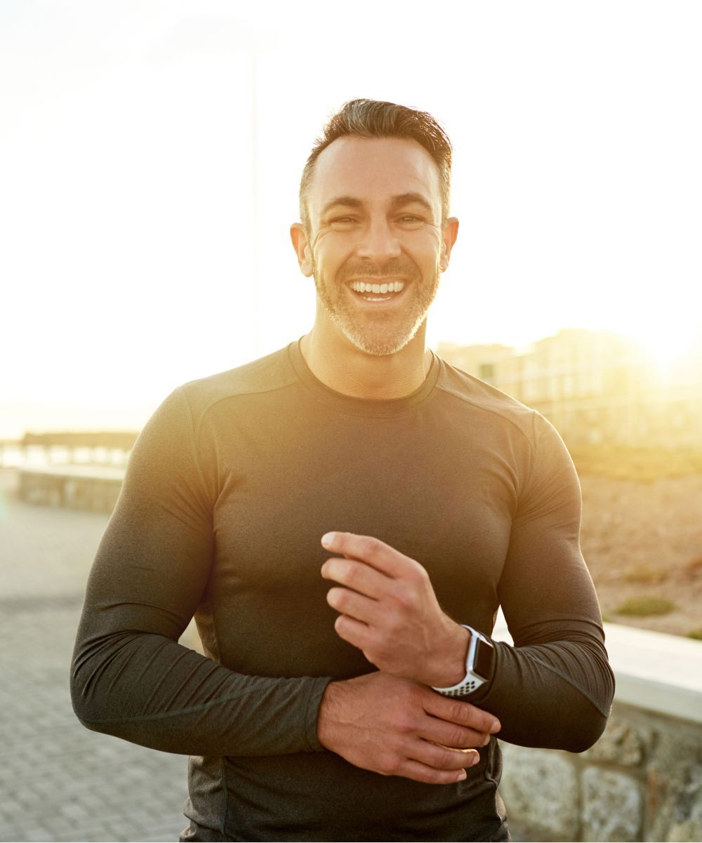 Smiling man enjoying outdoor sunshine moment.